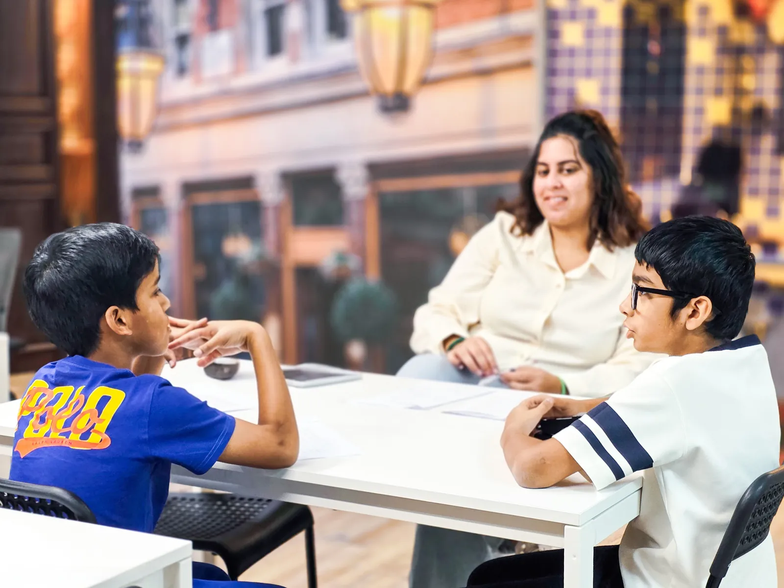 Students working with their teacher in an English session at Improve ME Institute