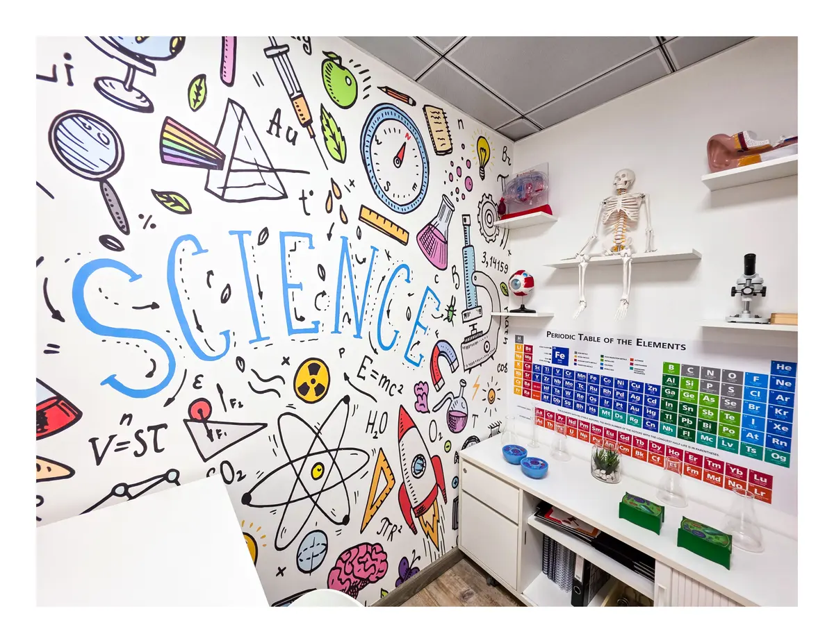 Science classroom with illustrated wall and periodic table at Improve ME Institute