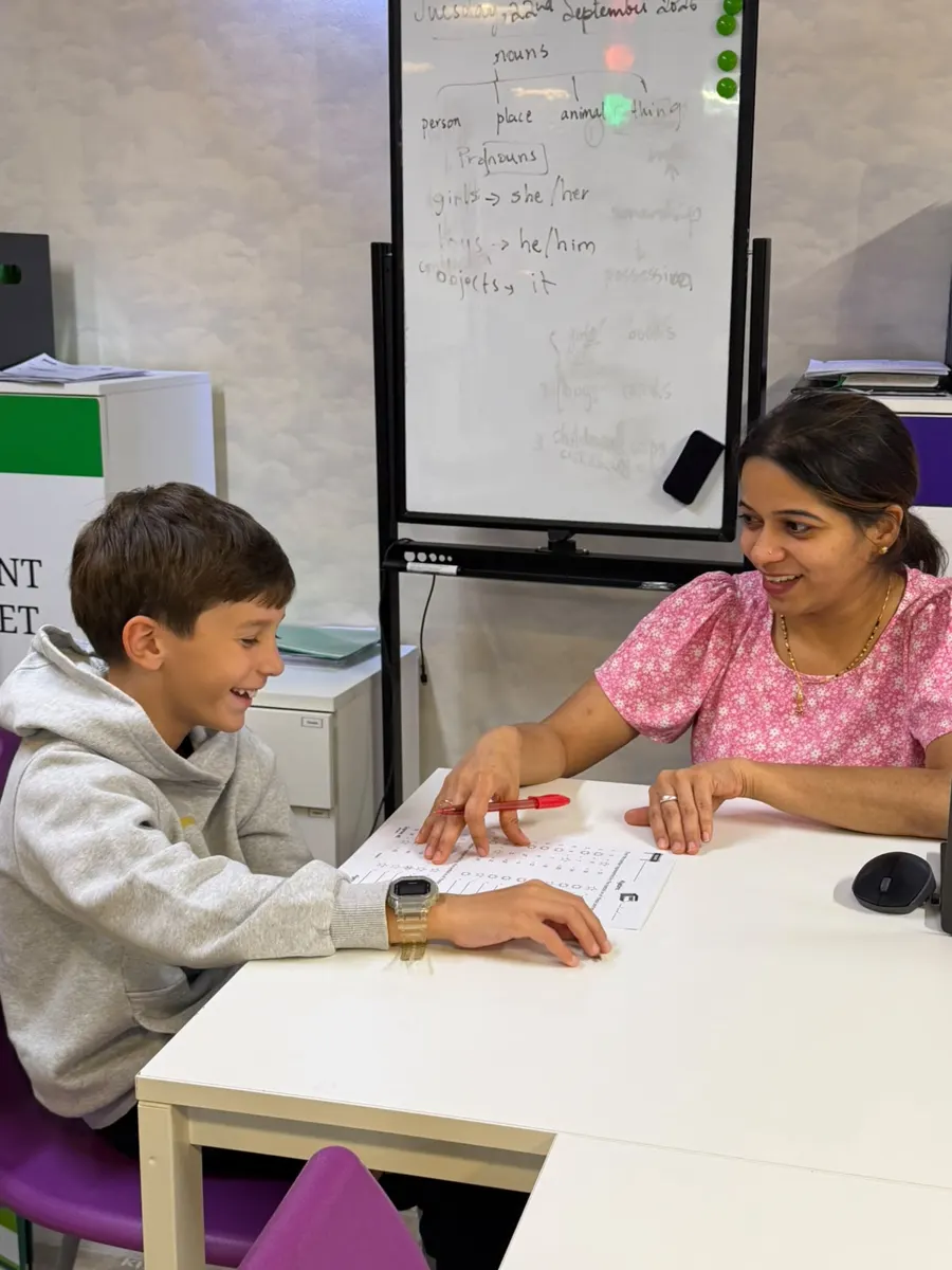 A teacher working one-to-one with a student at Improve ME Institute.